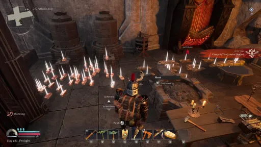 The Lord of the Rings: Return to Moria gameplay screenshot showing a camp under siege in the Lower Deeps, with piles of loot, meat pickups, hearths, and storage near a red dwarven gate.